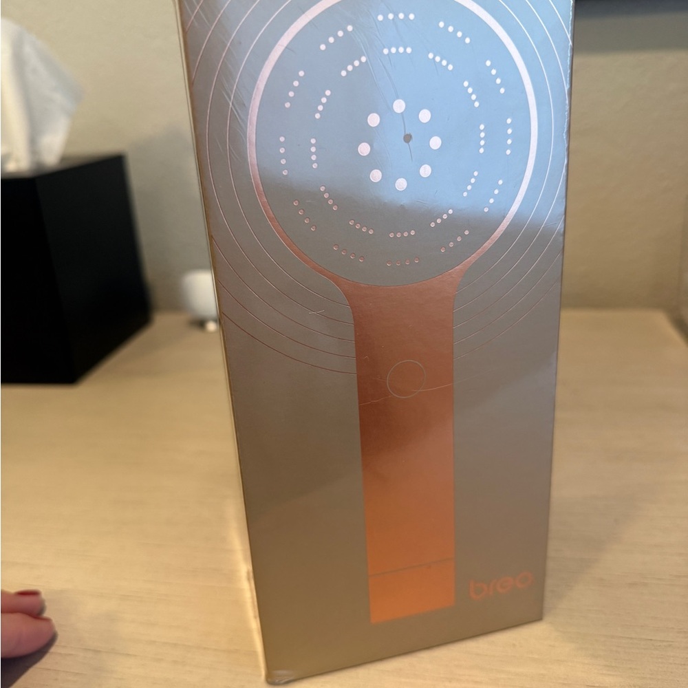 Breo Massager in Silver and Orange